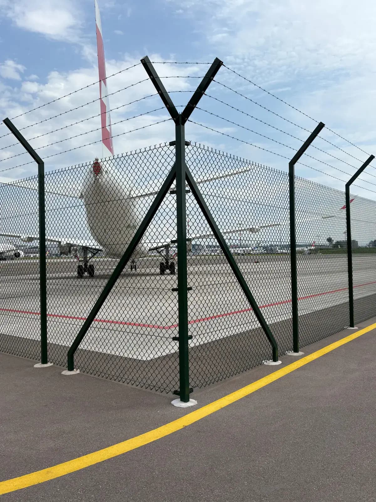 Eckpfosten des Flughafenzauns am Vorfeld des Flughafens Zürich